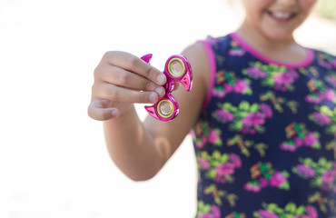 Girl holding  a fidget spinner toy