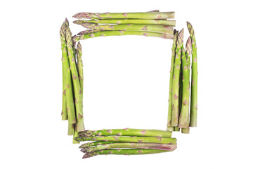 The frame made of fresh asparagus on a white background
