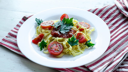 Pasta with sauce made of tomatoes, parsley, and basil