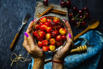 cherries in hands