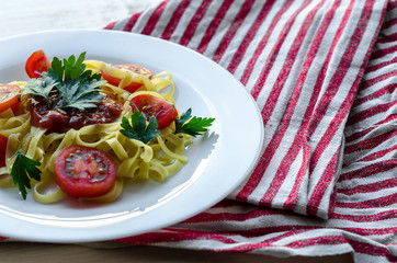 Pasta with sauce made of tomatoes, parsley, and basil