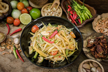 Thai papaya salad material (SomTum) on wooden background
