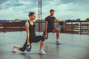Young couple exercising on the roof of a building © djile