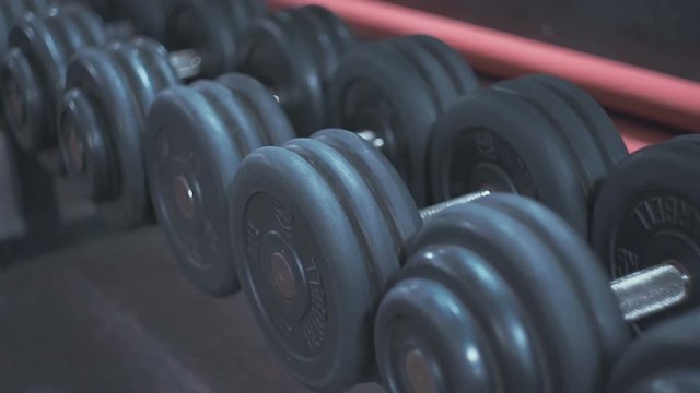 Dumbbells lie on the shelf close up