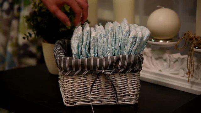 Hand picks diapers from the box