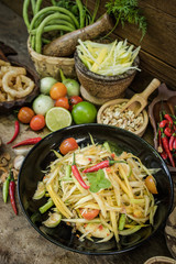 Thai papaya salad material (SomTum) on wooden background