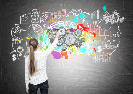 Blond woman drawing brain with cogs, scheme