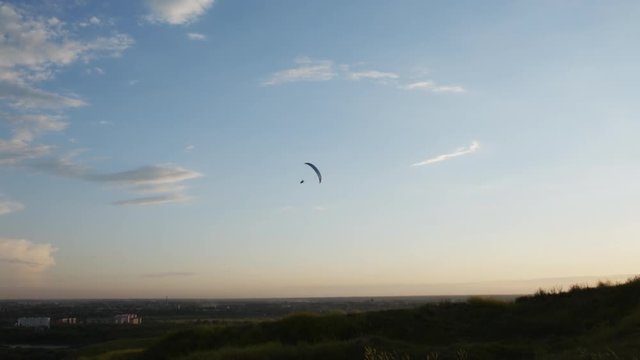 Silhouette of paraglider over the sunset