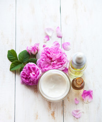 Fototapeta na wymiar Spa Set. Massage oil, pot of moisturizing face cream and lotion flower top view Flat lay