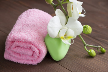 Obraz na płótnie Canvas Body care.Soap,white orhid and pink towel.Spa consept