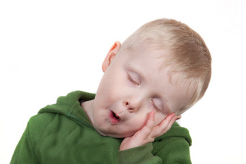 little boy falls asleep in studio background