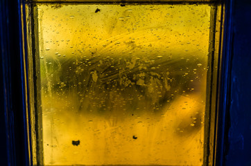 One colorful orange yellow stained glass window square macro closeup