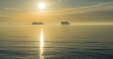 Naklejka na ściany i meble Sunset and cruise ship on the sea