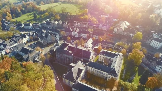 aerial drone view on historic small village named Kornelimuenster on a bright sunny autumn day