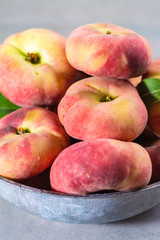 Fresh ripe chinese flat saturn peaches with leaves