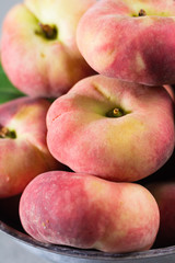 Fresh ripe chinese flat saturn peaches with leaves