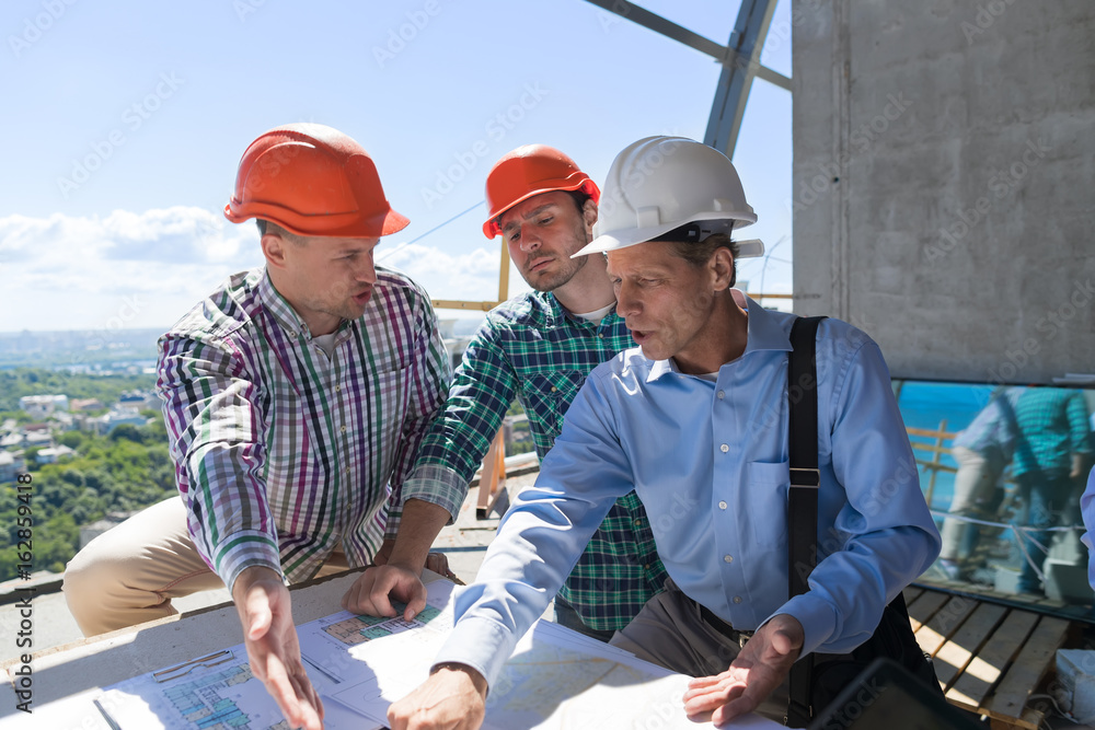 Poster team of builders working with blueprint on site architect explain construction plan to team og engin