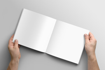 Blank square photorealistic brochure mockup on light grey background. 