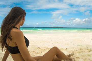 Fototapeta na wymiar Woman sunbathing on a beach