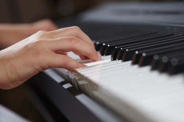 Fototapeta na wymiar female's hands playing piano