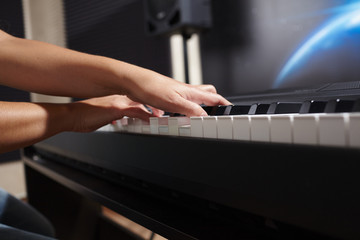 female's  hands playing piano