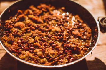 Food ingridients: meat, onion, ginger for recipe stewed beans with meat frying in a pen on a stove. Steps in cooking, process of preparing food. Concept of homemade healthy food.