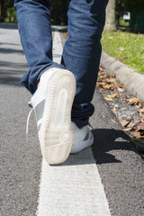 Human legs walking on a street