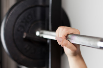Fototapeta premium woman's hand on a barbell 