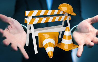 Businessman using digital 3D rendering under construction signs