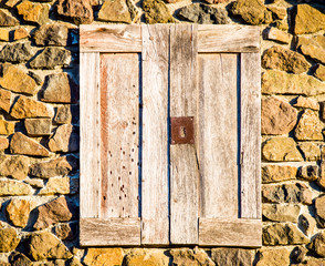 weathered wooden door in stone wall