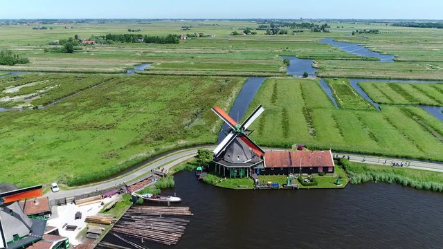 Aerial bird-eye view of Zaanse Schans Zaandam flying backwards from one of well-preserved historic windmills for tourists this is a popular cultural destination near Amsterdam Holland The Netherlands