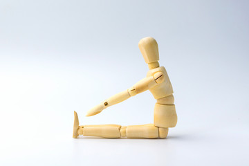 Wooden figure doll with Stretch arms and leg on white  for exercise training and helth concept