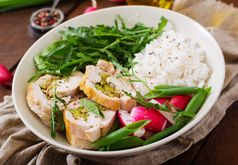 Healthy salad with chicken rolls, radishes, spinach,  arugula and rice. Proper nutrition. Dietary menu