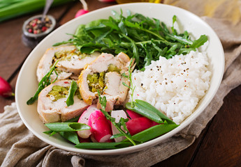 Healthy salad with chicken rolls, radishes, spinach,  arugula and rice. Proper nutrition. Dietary menu