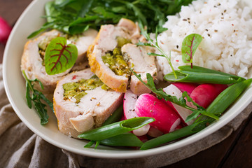 Healthy salad with chicken rolls, radishes, spinach,  arugula and rice. Proper nutrition. Dietary menu