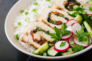 Healthy salad with chicken rolls, radishes, cucumber, green onion and rice. Proper nutrition. Dietary menu.