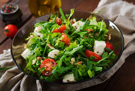Vitamin Salad of fresh vegetables, herbs, feta cheese and nuts. Dietary menu. Proper nutrition.