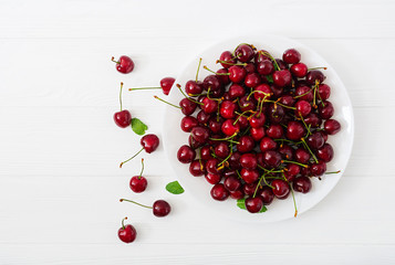 Ripe Sweet Cherry on a plate. Flat lay. Top view