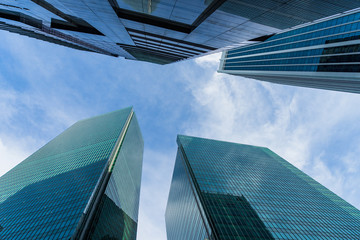 Bottom view of modern skyscrapers in business district against sky