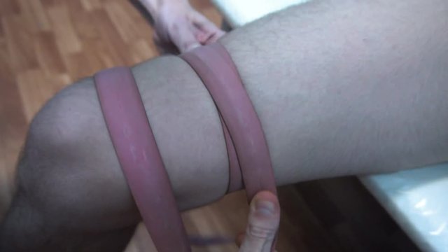 the doctor uses medical tourniquet to stop the bleeding.