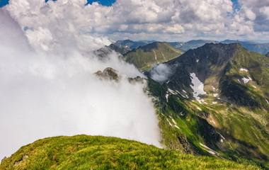 Steep slope on rocky hillside in fog