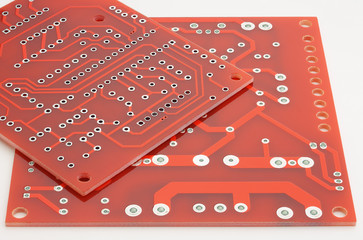 New printed circuit boards without electronic components on a white background.
