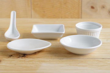 Fototapeta na wymiar white ceramic ware on wooden table