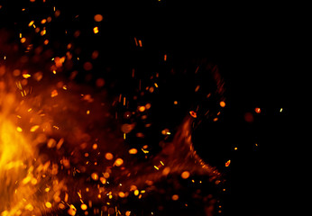 Flame of fire with sparks on a black background