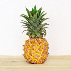 Ripe pineapple on a wooden table