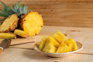 Ripe pineapple slice on a wooden table