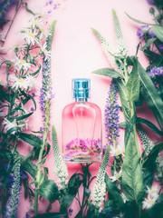 Floral Perfume bottle with plants and flowers, top view.   Perfumery, cosmetics, botanical...