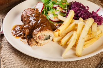 Pork roulade with french fries with salad