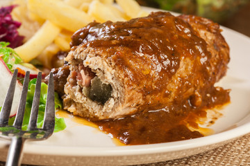 Pork roulade with french fries with salad