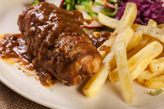 Pork roulade with french fries with salad